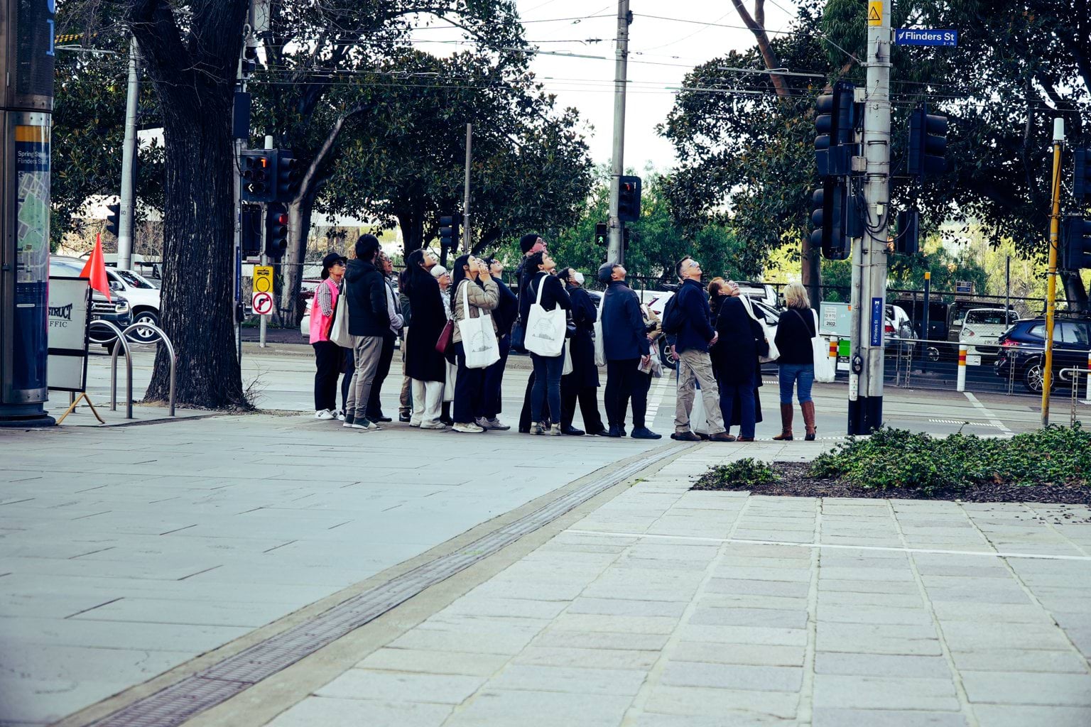 Walking tour group at 1 Spring Street looking up at the building